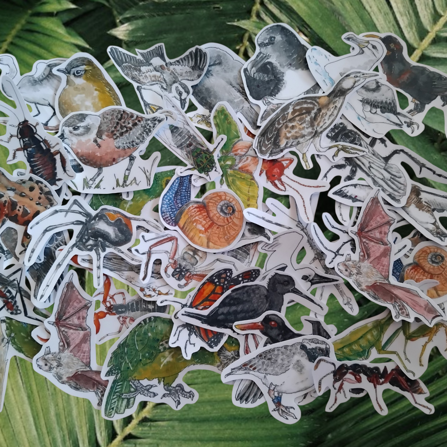 Collection of nature-themed stickers on green leaves