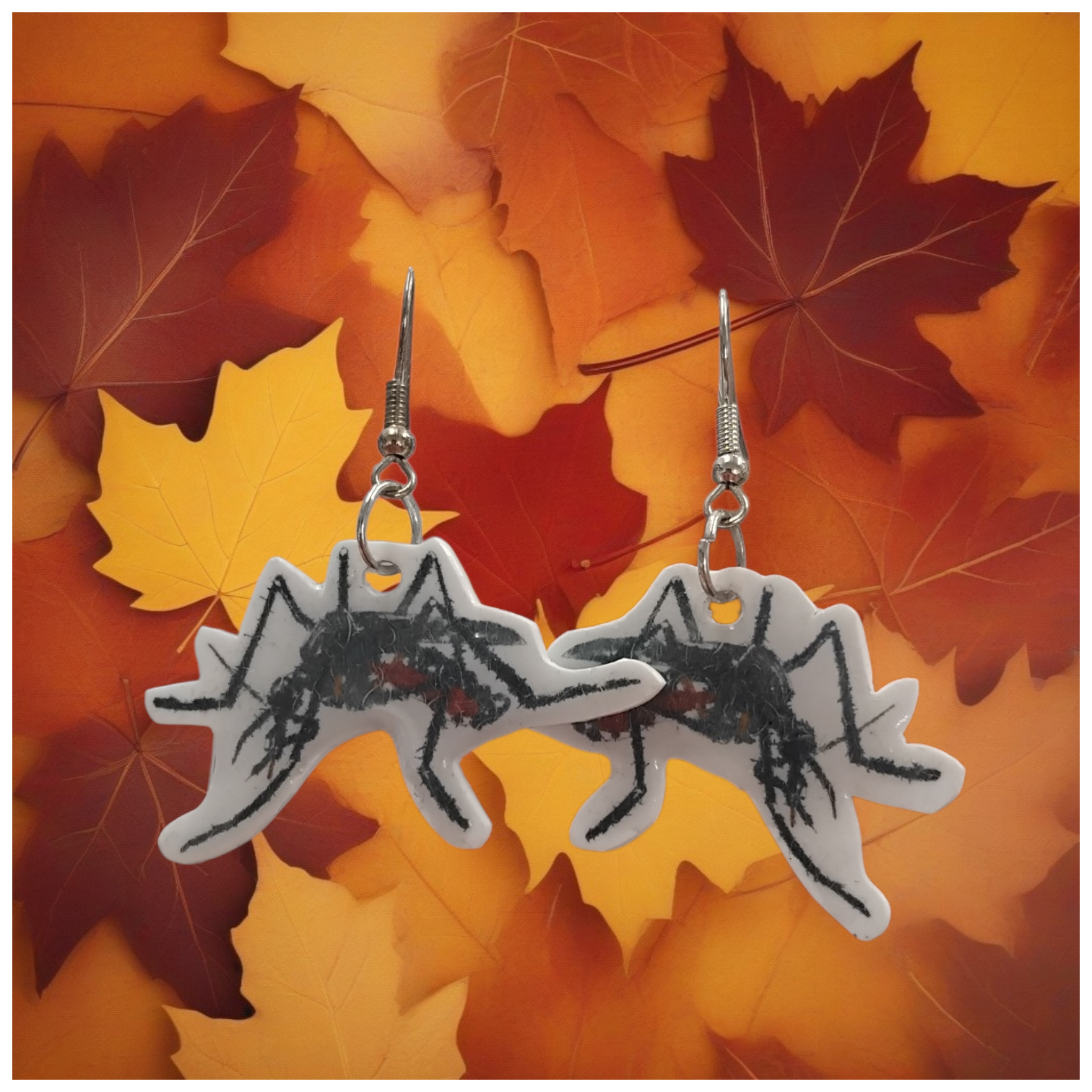 mosquito earrings on a background of autumn leaves